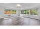 Bright living room with large windows offering lush views and luxury vinyl plank flooring at 2910 Hargill Dr, Orlando, FL 32806