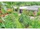 Lush front yard with a variety of plants, trees, and a well-manicured lawn leading to the home's entrance at 2910 Hargill Dr, Orlando, FL 32806