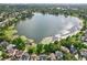 Stunning aerial view of lakefront neighborhood with lush landscaping and serene lake reflecting the sky at 2971 Cayman Way, Orlando, FL 32812