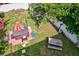 Aerial view of a backyard featuring a hot tub with an orange umbrella, picnic table and a storage shed at 2971 Cayman Way, Orlando, FL 32812