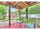 Outdoor oasis, covered patio with seating, a hot tub, and a well-maintained lawn at 2971 Cayman Way, Orlando, FL 32812