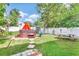 Inviting backyard featuring a hot tub with an orange umbrella, picnic table and a storage shed at 2971 Cayman Way, Orlando, FL 32812