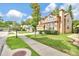 Well-maintained two-story home with a manicured lawn and mature trees at 2971 Cayman Way, Orlando, FL 32812
