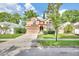 Charming two-story home with manicured lawn, trees, and a two-car garage at 2971 Cayman Way, Orlando, FL 32812
