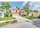 Front view of two-story home featuring well-kept landscaping and a driveway at 2971 Cayman Way, Orlando, FL 32812
