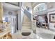 Elegant foyer features tile flooring, staircase, and view to the dining room at 2971 Cayman Way, Orlando, FL 32812