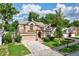 Charming two-story home boasts a well-manicured lawn, arched windows, and attached two-car garage at 2971 Cayman Way, Orlando, FL 32812