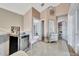 Hallway with tiled floors and a beverage cooler, with doorways that offer a glimpse into other rooms at 2971 Cayman Way, Orlando, FL 32812