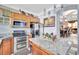 Well-equipped kitchen featuring stainless steel appliances, granite countertops, and wood cabinetry at 2971 Cayman Way, Orlando, FL 32812