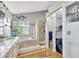 An elegant main bathroom with a garden tub, tiled shower, and access to the closet at 2971 Cayman Way, Orlando, FL 32812