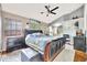 Bright main bedroom featuring a ceiling fan, a large leather sleigh bed, and a sitting area at 2971 Cayman Way, Orlando, FL 32812
