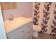 Bathroom features a single vanity, floral shower curtain, and tile flooring at 3012 S Semoran Blvd # S, Orlando, FL 32822