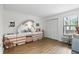 Spacious bedroom with a unique vanity, white closet, and light laminate flooring at 3012 S Semoran Blvd # S, Orlando, FL 32822