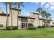 Exterior view of a modern multi-Gathering apartment building with well-manicured lawns and palm trees at 3012 S Semoran Blvd # S, Orlando, FL 32822