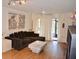 Spacious living room featuring wood floors, modern artwork, and a comfortable sectional sofa at 3012 S Semoran Blvd # S, Orlando, FL 32822
