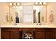 Bathroom features double sinks, vanity and two large mirrors with overhead vanity lighting at 312 Trieste Loop, Lake Mary, FL 32746