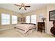 Bedroom with carpet, ceiling fan, three windows with blinds, and various decor at 312 Trieste Loop, Lake Mary, FL 32746