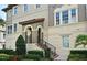 Elegant home exterior featuring a covered entryway, manicured landscaping, and a welcoming staircase at 312 Trieste Loop, Lake Mary, FL 32746