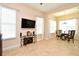 Open living area with tile flooring, neutral walls, a media center and lots of light from the multiple windows at 312 Trieste Loop, Lake Mary, FL 32746