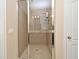 Shower room with tile walls, glass doors, shower head, and shower caddy at 312 Trieste Loop, Lake Mary, FL 32746