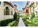 Charming community walkway with lush landscaping, leading through picturesque townhome exteriors at 312 Trieste Loop, Lake Mary, FL 32746