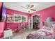 Fun bedroom with pink walls and lots of kid-friendly furniture and storage at 3251 Wickersham Ct, Orlando, FL 32806