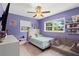 Bright bedroom with vibrant purple walls, and ample natural light at 3251 Wickersham Ct, Orlando, FL 32806