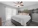 Cozy bedroom with a large bed, ceiling fan, and a window with sheer curtains at 3251 Wickersham Ct, Orlando, FL 32806