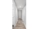 Bright hallway with wood floors and fresh paint leading to other rooms at 3251 Wickersham Ct, Orlando, FL 32806