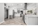 Bright kitchen features stainless steel appliances, white cabinetry, and wood-look flooring at 3251 Wickersham Ct, Orlando, FL 32806