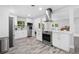 Modern kitchen with stainless steel appliances, white cabinets, and a stylish range hood at 3251 Wickersham Ct, Orlando, FL 32806