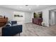 Living room with wood floors, a comfortable couch, and a red accent cabinet at 3251 Wickersham Ct, Orlando, FL 32806