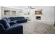 Comfortable living room with fireplace, wood floors, and large sectional couch at 3251 Wickersham Ct, Orlando, FL 32806