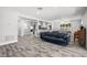 Open-concept living room showcasing a blue sofa, modern lighting, and seamless flow to the kitchen at 3251 Wickersham Ct, Orlando, FL 32806