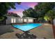Inviting backyard pool illuminated by twilight, creating a serene and picturesque outdoor oasis at 3251 Wickersham Ct, Orlando, FL 32806