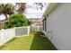Backyard features a well-maintained lawn, a white picket fence, and a partial view of the house at 342 Lakebreeze Cir, Lake Mary, FL 32746