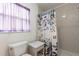 Shower and toilet in the bathroom, complemented by a stylish shower curtain and neutral tiling at 342 Lakebreeze Cir, Lake Mary, FL 32746