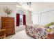Well-lit bedroom with white walls, plush carpeting, and a cheerful floral pattern on the bedspread at 342 Lakebreeze Cir, Lake Mary, FL 32746