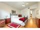 Well-lit bedroom featuring wood floors, a comfortable-looking bed, and a view into the bathroom at 342 Lakebreeze Cir, Lake Mary, FL 32746