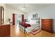 Bright bedroom boasts wood floors, an open door to the outside, and a decorative metal bed frame at 342 Lakebreeze Cir, Lake Mary, FL 32746