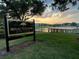Scenic sunset view of Reflection Park's lakefront with a fishing pier at 342 Lakebreeze Cir, Lake Mary, FL 32746