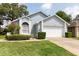 Charming single-story home featuring a two-car garage, landscaped yard, and light blue paint at 342 Lakebreeze Cir, Lake Mary, FL 32746