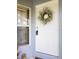 Close up of front door, wreath and lockbox with window beside the door at 342 Lakebreeze Cir, Lake Mary, FL 32746