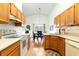 Bright kitchen with wooden cabinets, modern appliances, and adjacent dining area for Gathering meals at 342 Lakebreeze Cir, Lake Mary, FL 32746