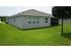 Exterior view of home and backyard, showing windows and screened-in patio at 444 Halter Dr, Apopka, FL 32712