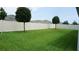 Spacious backyard with lush green grass, enclosed by a white fence for privacy at 444 Halter Dr, Apopka, FL 32712