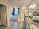 Bright bathroom features a soaking tub, glass shower, double granite vanity, and tiled floors in a neutral palette at 444 Halter Dr, Apopka, FL 32712