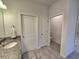 Modern bathroom features a granite countertop, undermount sink, stylish tiled floor, and access to a private toilet room at 444 Halter Dr, Apopka, FL 32712