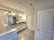 A well-lit bathroom featuring double sinks, a glass-enclosed shower, and neutral-toned walls with tile flooring at 444 Halter Dr, Apopka, FL 32712