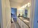 Bathroom with double sink vanity, granite counters, and views to the bedroom at 444 Halter Dr, Apopka, FL 32712